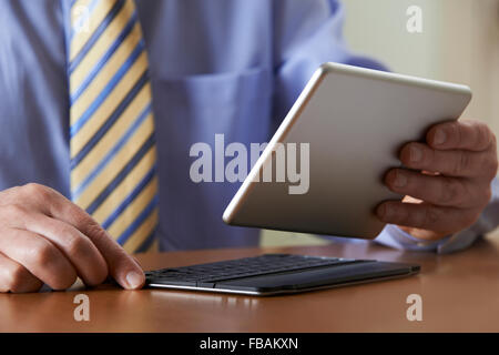 Businessman Using Digital Tablet With Detachable Keyboard Stock Photo
