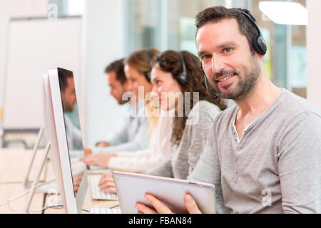 View of a Young attractive man working in a call center Stock Photo