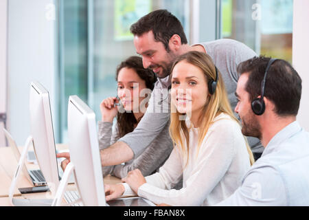 View of a Young attractive people learning their new job at call center Stock Photo