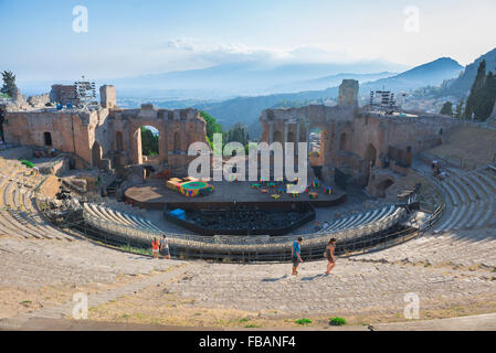 Taormina greek theatre, view of tourists in summer walking in the auditorium of the ancient Greek theater (Teatro Greco) in Taormina, Sicily.