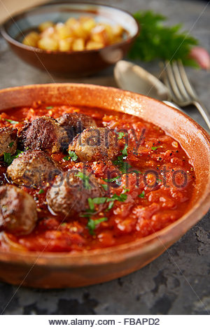 meatballs albóndigas in a tomato sauce with patatas gravas Stock Photo
