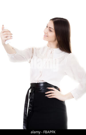 Happy beautiful girl in black skirt and white shirt uniform, office worker using mobile phone app, taking picture, selfie, self- Stock Photo