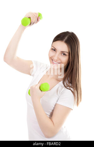 Young smiling woman in white t-shirt trains biceps lifting dumbbell weights, workout, doing fitness exercises. Isolated on white Stock Photo