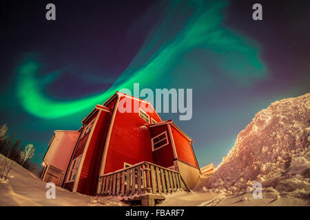 Aurora Borealis over Norwegian houses Stock Photo