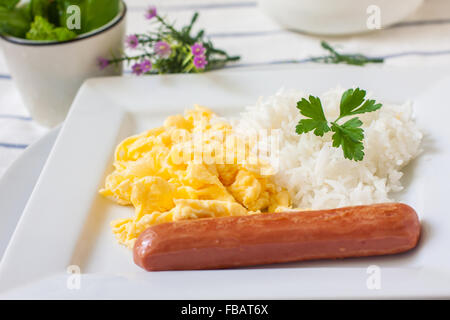 continental breakfast with scrambled eggs sausage and boiled rice Stock Photo