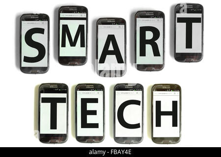 Smart Tech spelled out on mobile phone screens photographed against a white background. Stock Photo