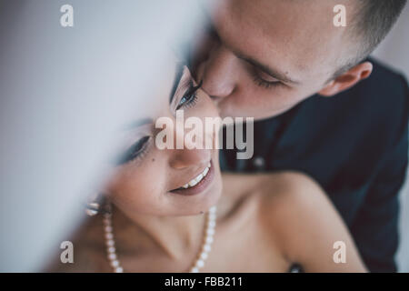 Beautiful European bridal couple in the hotel room Stock Photo