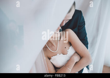 Bride and groom in a hotel room Stock Photo