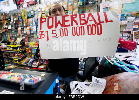 Boston Massachusetts USA 13th January, 2016. A clerk holds a handmade Powerball sign inside a grocery store that sells lottery tickets  in Boston, Massachusetts, Wednesday, Jan. 13, 2016. Stock Photo