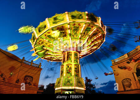 Low Angle View of a Moving Chain Swing Ride at Dusk, Prater Amusement Park, Vienna, Austria Stock Photo