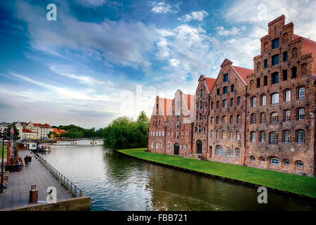 Low Angle View of Old Brick Crow-Stepped Gable Warehouse Buildings Along a Canal, Old Town Lubeck, Schleswig-Holstein, Germany Stock Photo