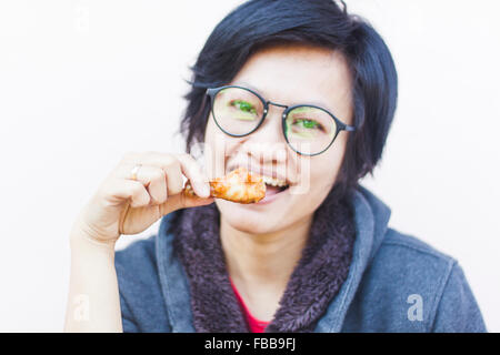 Asian woman eating delicious chicken, stock photo Stock Photo