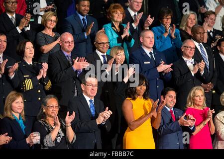 Washington DC, USA. 12th January, 2016. The First Lady applauds her husband President Barack Obama as he begins his final State of the Union address to a joint session of Congress on Capitol Hill January 12, 2016 in Washington, DC. Stock Photo