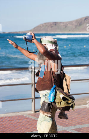 Old Hippy with Polaroid camera, who used to take and sell photos of toursit at beachfront bars in Las Palmas, Gran Canaria. Stock Photo