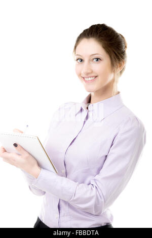 Friendly smiling beautiful girl writing in notepad, student or office woman in formal wear taking notes Stock Photo