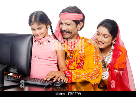 3 indian rural Gujrati Parents and kid doughter sitting Computer Education Stock Photo