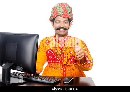 1 indian Rural Gujrati man Computer Education and Thumbs Up showing Stock Photo
