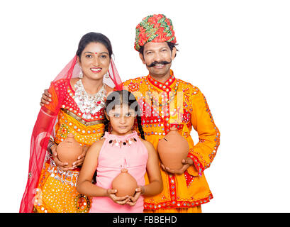3 indian rural Gujrati Parents and kid doughter Piggy Bank saving money Stock Photo