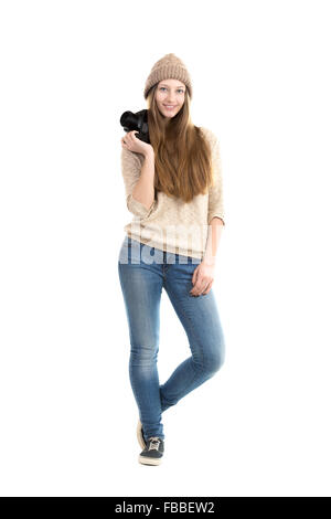 Cheerful smiling female photographer in casual clothes walking with slr camera, photography hobby, teenagers activity Stock Photo