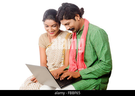 2 indian Rural Married Couple sitting laptop Working Stock Photo