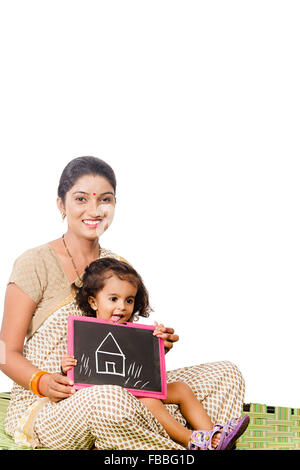 2 indian rural mother and kid daughter slate Board Drawing Dreaming new House Stock Photo