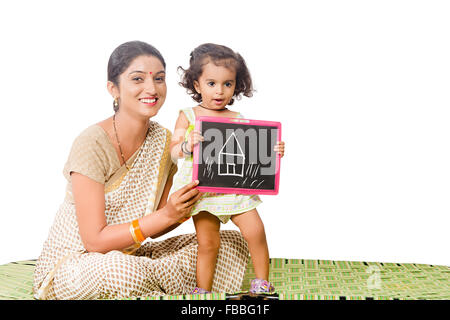 2 indian rural mother and kid daughter slate Board Drawing Dreaming new House Stock Photo