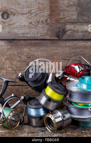 Premium Photo  Accessories for fishing on the background of wood. reel,  fishing line, float, net hooks, lures for fishing. top view. still life.  copy space