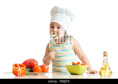 Chef girl preparing and tasting healthy food over white background Stock Photo