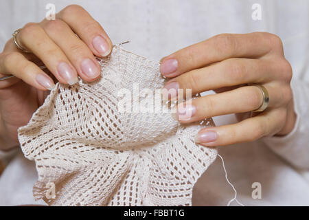 crochet woman crafting making knitting pattern knitted handmade lace detail stitch texture beige yarn openwork hands Stock Photo