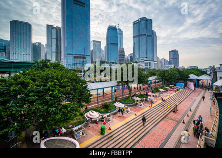 View of a waterfront promenade and skyscrapers along the Victoria Harbour, in Hong Kong, Hong Kong. Stock Photo