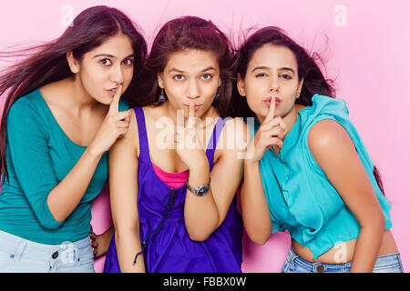 3 indian Young Womans friends finger mouth Silence Stock Photo