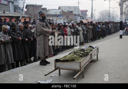 (160114) -- SRINAGAR, Jan. 14, 2016 (Xinhua) -- Kashmiri people offer funeral prayers for Owais Bashir Malik, an engineering student, during his funeral procession in Srinagar, summer capital of Indian-controlled Kashmir, Jan. 14, 2016. Indian police fired warning shots and tear gas shells to disperse hundreds of Kashmiri protesters who had blocked road to Srinagar airport and shouting anti-India slogans after the body of a college student with his throat slit was found in the Indian-controlled Kashmir. The protesters accused the Indian army of torturing and killing the student. However, the a Stock Photo