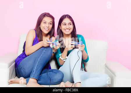 2 indian Young Womans friends Playing Video game Stock Photo