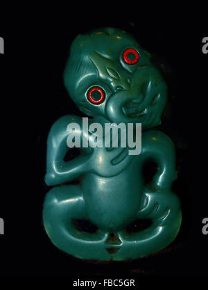 Exhibit specimen of a Maori Greenstone Hei Tiki .The name translates as hei (suspend around the neck) and tiki (man) - New Zealand Stock Photo