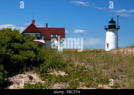 Race Point Lighthouse lies on the edge of the Cape Cod National Seashore, near Provincetown, Massachusetts, on a warm summer day. Stock Photo