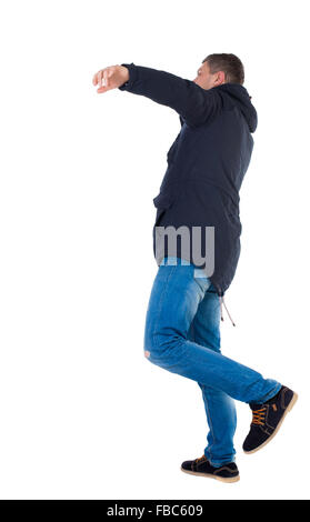 Balancing young man in parka. or dodge the falling man. Rear view people collection. backside view of person. Isolated over white background. The falling man. Stock Photo