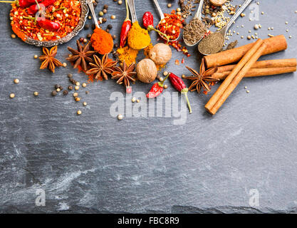 Aromatic spices with pepper and turmeric powders,cumin and coriander seeds, chili flakes , anise, nutmeg and cinnamon Stock Photo