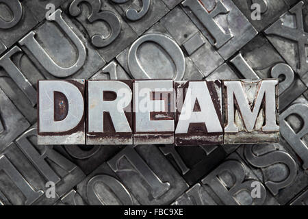 dream word concept made from metallic letterpress blocks on many letters background Stock Photo