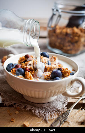 Homemade granola with milk and fresh blueberries Stock Photo