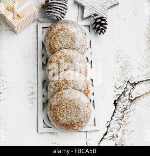 Gingerbread Cookies with Christmas Ornaments on Painted Wood Stock Photo
