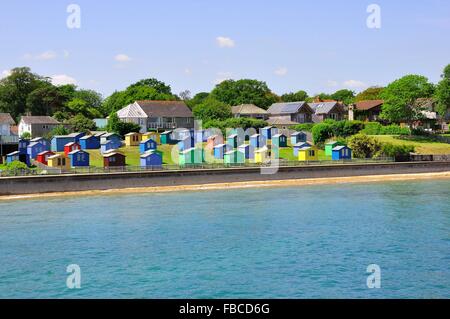 Brightly coloured beach huts on the seafront at Bembridge, Isle of Wight Stock Photo