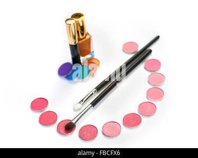 Stil life with eye shadows and make-up brushes on white Stock Photo