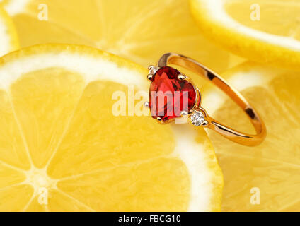 jewellery ring with big gem on lemon background, horizontal composition Stock Photo