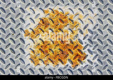 A rusted area on an industrial metal sheet Stock Photo