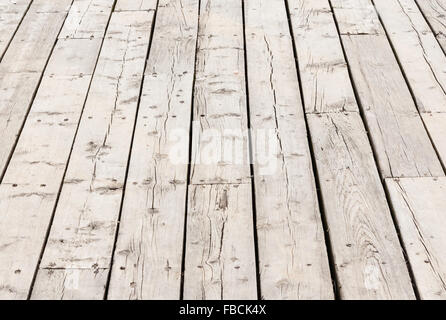 Cracked weathered gray wooden deck surface boards in perspective. Stock Photo