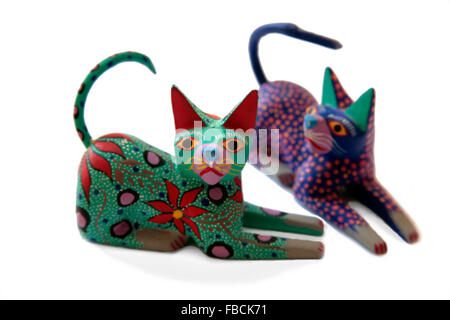 Mexican carved and painted wooden cat figurines from Oaxaca State. Stock Photo