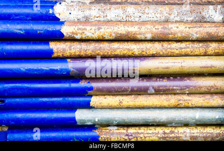 Old blue scaffolding bars with rust damage Stock Photo