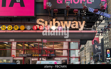 A brightly illuminated Subway sign and entrance located in Times Square, New York City. Stock Photo