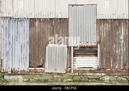 Rusty metal sheets on the wall of an old building Stock Photo