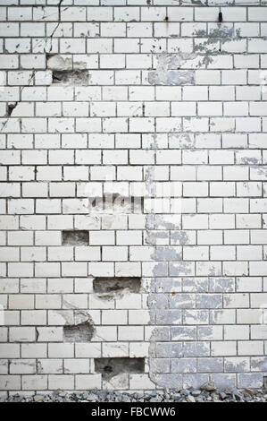 Part of a damaged white brick wall Stock Photo